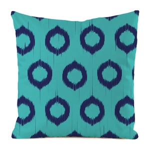 Close-up of circular ikat pattern texture on turquoise faux silk decorative pillow cover