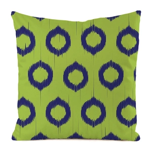 Detailed texture of lime green ikat throw pillow case with navy blue circular patterns