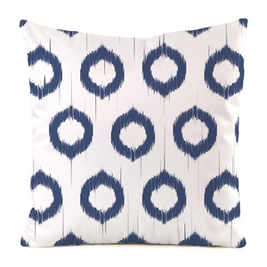 Detail of square cushion cover with navy blue ikat circle pattern on white silk fabric