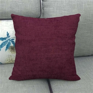 Close-up of wine red linen textured cushion cover on a grey sofa for home decor