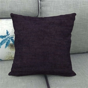 Close-up of deep purple linen texture sofa cushion cover on a grey couch