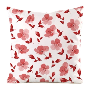 Detailed close-up of pink floral pattern on a white square cushion cover with leaf accents