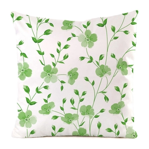 Close-up of square floral cushion cover with delicate green flower pattern and soft fabric
