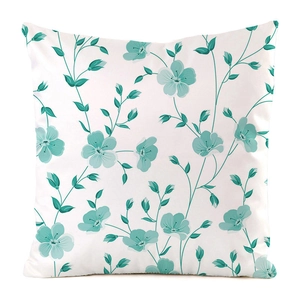 Detailed view of floral cushion cover with turquoise blossoms on white satin fabric