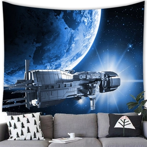 Close-up of spaceship over blue planet tapestry on white wall above grey sofa