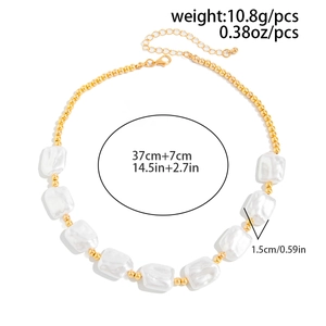 Detailed view of beaded necklace with gold metal beads and baroque faux pearls