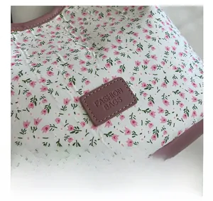 Detailed macro view of the floral canvas fabric and fashion leather logo patch