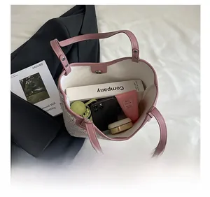 Spacious floral tote bag showing interior capacity for phone, cosmetics, and books