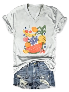 Detail view of V-neck white T-shirt featuring colorful fruit print and denim shorts