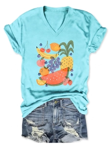 Detail of V-neck light blue T-shirt with vibrant fruit illustrations and denim shorts