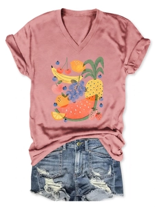 Detailed flat lay of V-neck fruit print t-shirt and distressed denim shorts ensemble