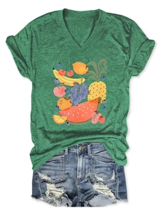 Flat lay of green V-neck T-shirt with fruit print and blue ripped denim shorts