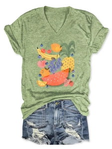 Detail of V-neck short sleeve green t-shirt with colorful tropical fruit print design
