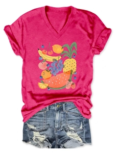 Detail of V-neck magenta T-shirt featuring hand-drawn mixed fruit print with denim shorts
