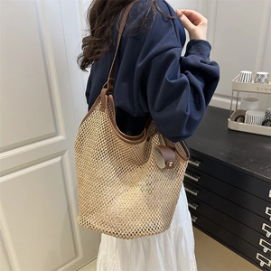 Large capacity straw woven tote bag with brown leather trim for summer beach vacations