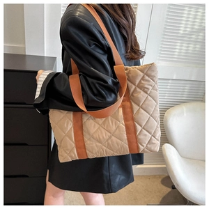 Detailed side view of khaki quilted tote bag showing large capacity and soft texture
