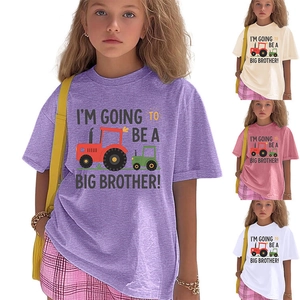 Detail view of cotton kids T-shirts featuring colorful tractor graphics and brother text