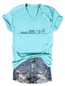 Detail of light blue V-neck t-shirt with book and cup print paired with denim shorts
