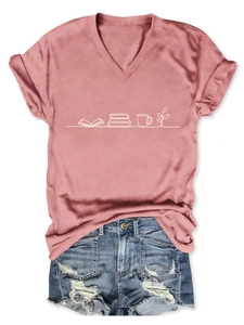 Flat lay detail of pink V-neck T-shirt with book print and ripped denim shorts
