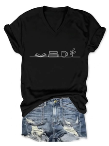 Detail of V-neck black T-shirt with book and cup graphic paired with ripped denim shorts