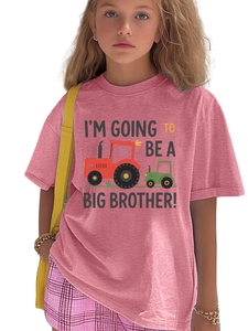 Detail of cartoon tractor print and I'm Going To Be A Big Brother text on pink t-shirt