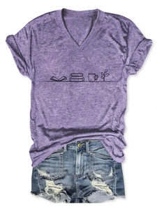 Flat lay of purple V-neck T-shirt with book and coffee print paired with denim shorts