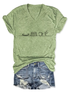 Detail of V-neck t-shirt with book and coffee cup graphic paired with denim shorts