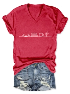 Detail of red V-neck T-shirt with book print paired with distressed denim shorts