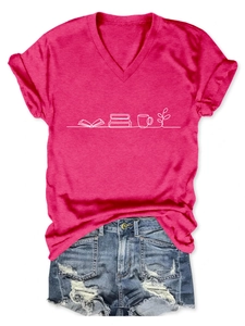 Flat lay of pink V-neck T-shirt with white book and cup print paired with denim shorts