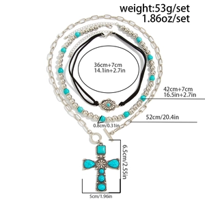Detailed view of layered turquoise necklaces showing chain lengths and cross pendant size