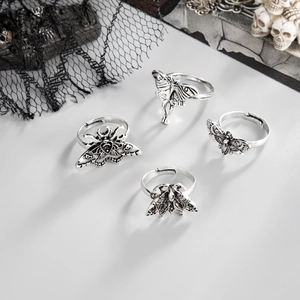 Macro view of vintage silver moth rings with gothic textures and adjustable bands