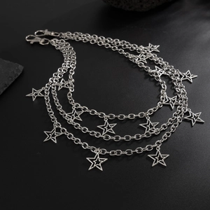 Close-up of triple-layered silver metal chain with hollow star charms and lobster clasps