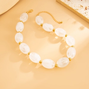 Detailed shot of ethnic resin beaded necklace with gold spacers and lobster clasp