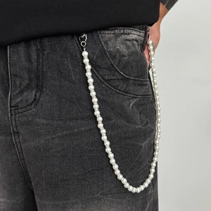 Men's pearl trousers chain with rhinestone spacers on grey denim jeans for a stylish look