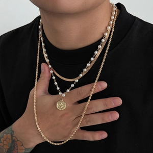 Three-piece layered gold necklace set with flat snake chain, pearl beads and star pendant