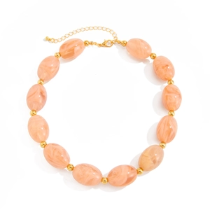 Ethnic style necklace with large marble-textured resin beads and golden spacers