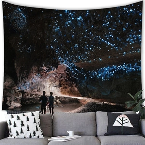 Detailed view of large cave tapestry with glowing blue lights in a cozy living room