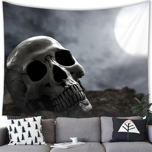 Dark gothic skull tapestry with moon and clouds hung over a sofa in a modern room