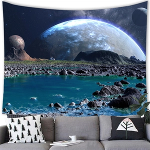 Detail of space-themed sci-fi tapestry with alien planets hanging over a grey sofa