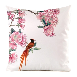 Macro detail of bird and floral pattern on silk-feel decorative square cushion cover