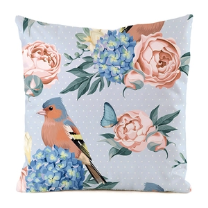 Detail of floral and bird print on square faux silk pillowcase with light blue polka dot base