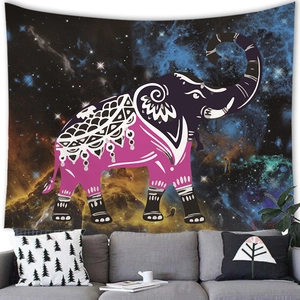 Mandala elephant tapestry with starry nebula background hanging over a modern sofa