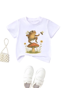 Flat lay of white kids t-shirt with kung fu frog on mushroom and pearl handbag accessory