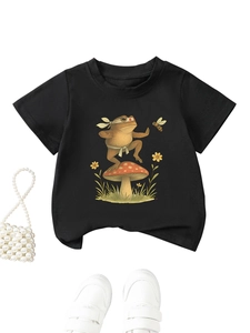 Flat lay of black kids T-shirt featuring kung fu frog and mushroom with white sneakers