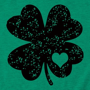 Close-up of distressed black four-leaf clover print with a heart on a green cotton T-shirt