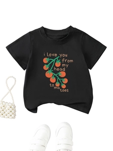 Close-up of children's black T-shirt with tomato print and pearl bead bag