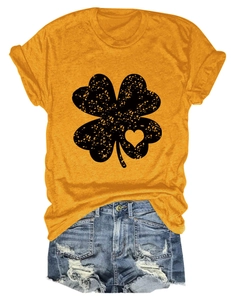 Detail of clover print on yellow T-shirt paired with frayed denim shorts