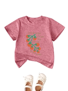 Detail of pink cotton T-shirt with tomato print and white bow shoes for children