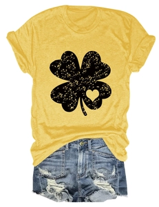 Flat lay of yellow cotton T-shirt with clover heart print and distressed denim shorts