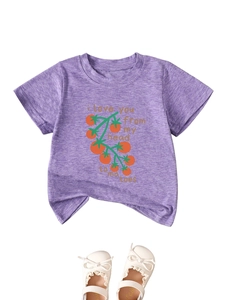 Detail of purple cotton T-shirt with tomato print and white Mary Jane shoes with bows